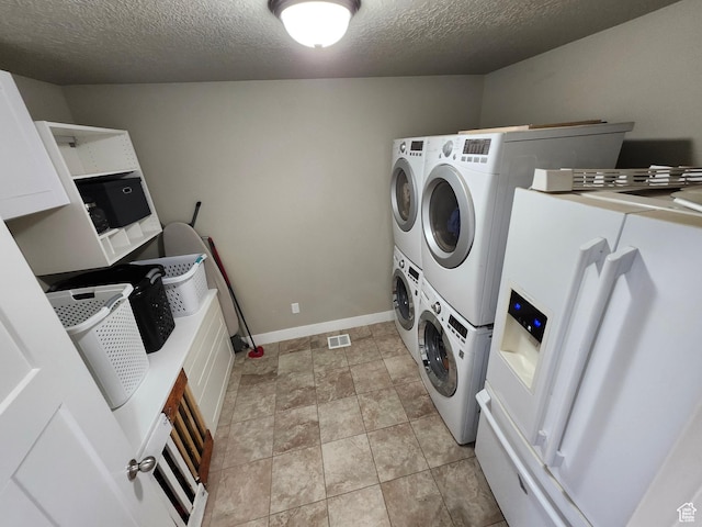 9362 N Sunnyvale Dr, Eagle Mountain, UT 84005 - washroom featuring stacked washer and clothes dryer, a textured ceiling, and baseboards