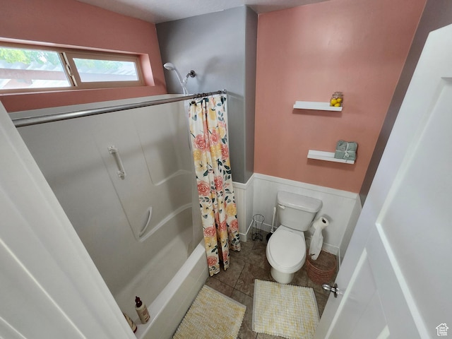 9362 N Sunnyvale Dr, Eagle Mountain, UT 84005 - full bathroom featuring wainscoting, toilet, tile patterned flooring, and shower / bathtub combination with curtain