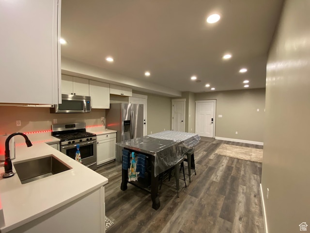9362 N Sunnyvale Dr, Eagle Mountain, UT 84005 - kitchen with stainless steel appliances, a sink, recessed lighting, white cabinets, and dark wood-type flooring