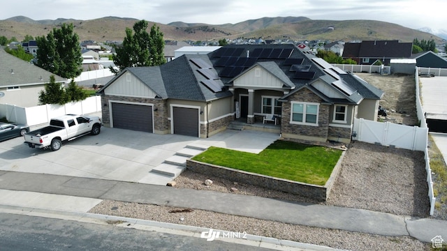 9362 N Sunnyvale Dr, Eagle Mountain, UT 84005 - craftsman-style home featuring a gate, stone siding, an attached garage, and a mountain view