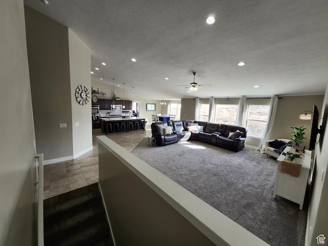 9362 N Sunnyvale Dr, Eagle Mountain, UT 84005 - living area featuring baseboards, a textured ceiling, a ceiling fan, dark colored carpet, and recessed lighting