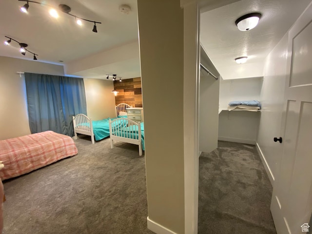 9362 N Sunnyvale Dr, Eagle Mountain, UT 84005 - carpeted bedroom featuring rail lighting and baseboards