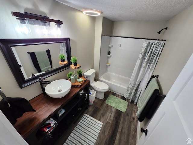 9362 N Sunnyvale Dr, Eagle Mountain, UT 84005 - bathroom with a textured ceiling, wood finished floors, toilet, shower / bathtub combination with curtain, and vanity