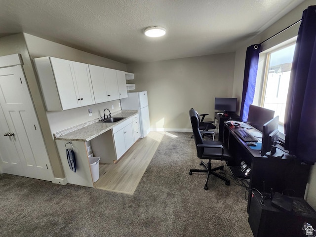 9362 N Sunnyvale Dr, Eagle Mountain, UT 84005 - home office with a sink, light colored carpet, baseboards, and a textured ceiling