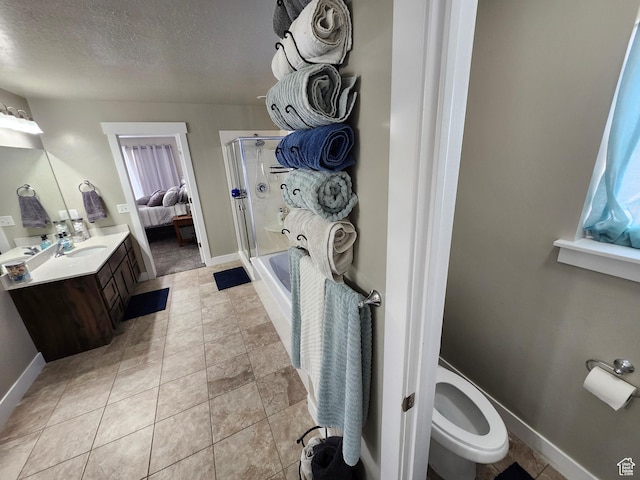 9362 N Sunnyvale Dr, Eagle Mountain, UT 84005 - full bathroom featuring a stall shower, a textured ceiling, baseboards, vanity, and toilet
