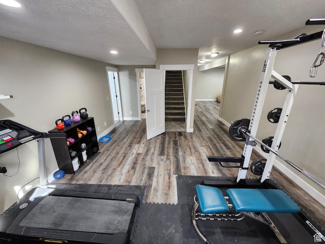 9362 N Sunnyvale Dr, Eagle Mountain, UT 84005 - exercise room featuring wood finished floors, baseboards, a textured ceiling, and recessed lighting