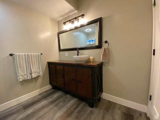 9362 N Sunnyvale Dr, Eagle Mountain, UT 84005 - bathroom with wood finished floors, baseboards, and vanity