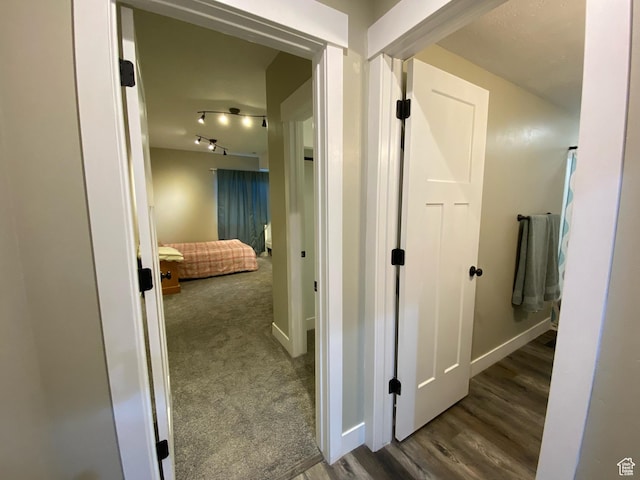 9362 N Sunnyvale Dr, Eagle Mountain, UT 84005 - corridor featuring baseboards, wood finished floors, and track lighting