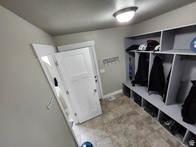 9362 N Sunnyvale Dr, Eagle Mountain, UT 84005 - mudroom with a textured ceiling and baseboards