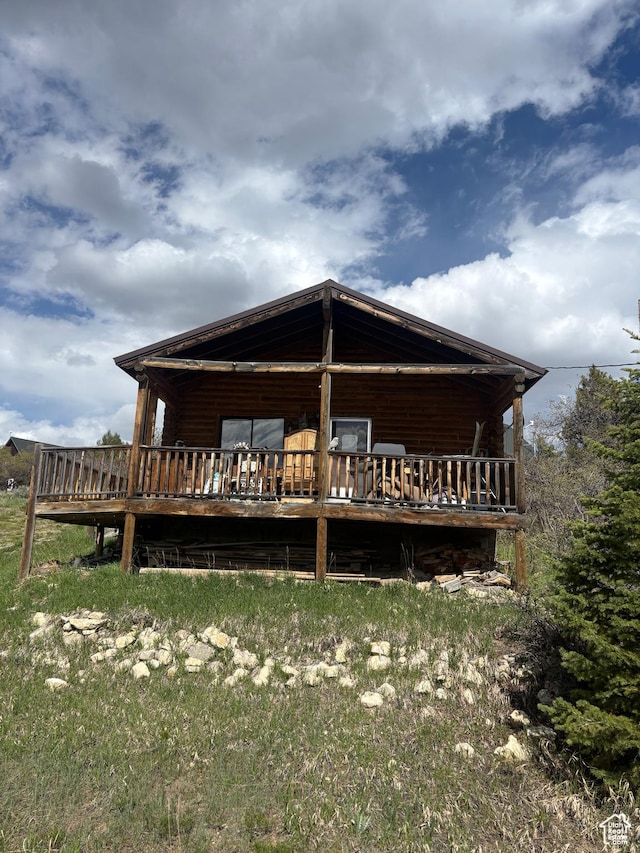 rear view of property with a wooden deck