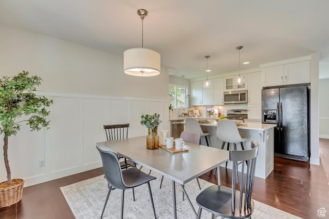 5277 S Morning Mesa Cir, Salt Lake City, UT 84123 - dining space with a decorative wall, dark wood-style floors, wainscoting, and recessed lighting