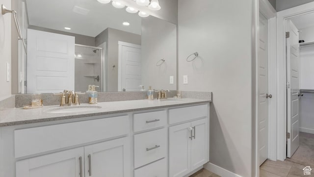 3734 W 2750 N, Lehi, UT 84043 - full bathroom with a shower stall, double vanity, baseboards, a spacious closet, and recessed lighting