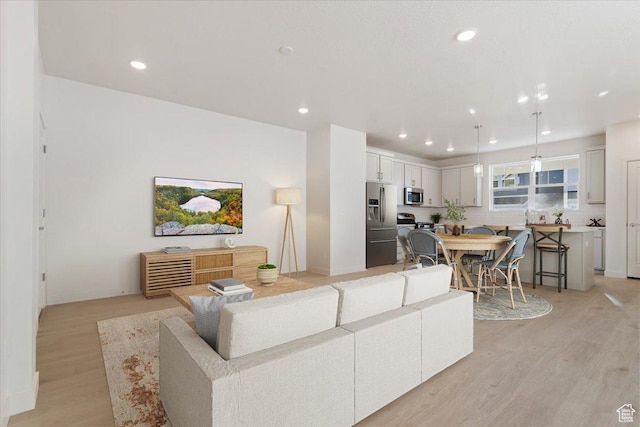 living area featuring recessed lighting and light wood-style flooring