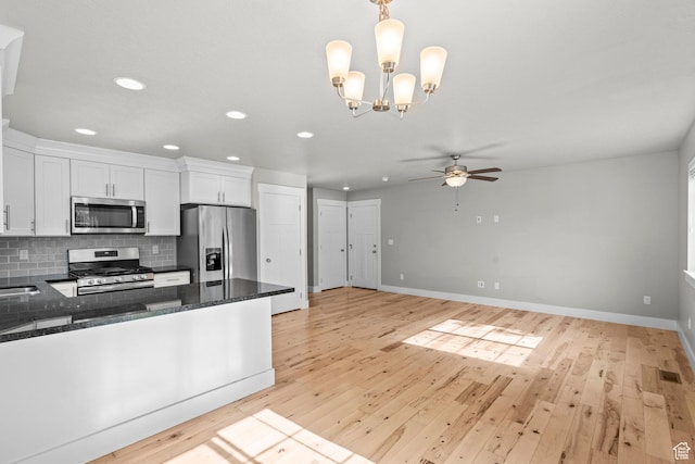 kitchen with appliances with stainless steel finishes, white cabinetry, light wood-style flooring, ceiling fan, and recessed lighting