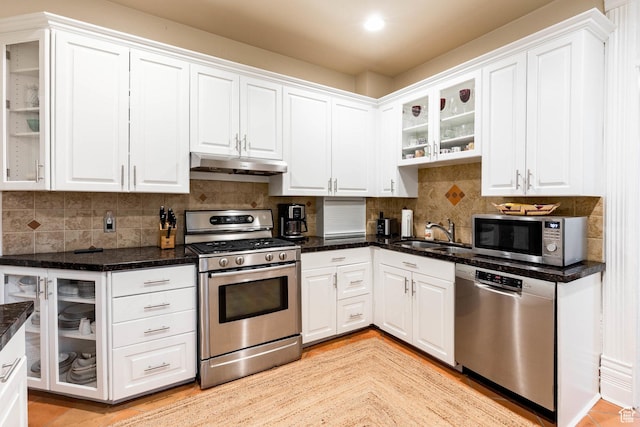 914 E 1st Ave, Salt Lake City, UT 84103 - kitchen featuring stainless steel appliances, under cabinet range hood, a sink, and white cabinets