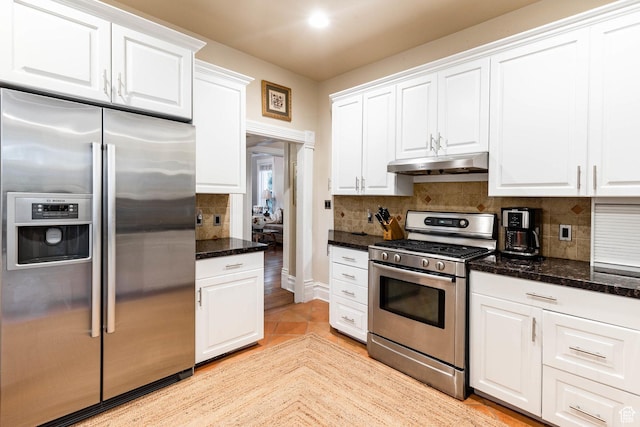 914 E 1st Ave, Salt Lake City, UT 84103 - kitchen featuring stainless steel appliances, under cabinet range hood, white cabinets, and decorative backsplash