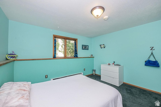 carpeted bedroom with a baseboard heating unit and baseboards