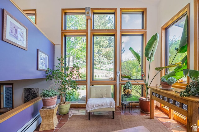 sunroom / solarium with a baseboard heating unit
