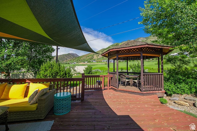 wooden deck with a gazebo and a mountain view
