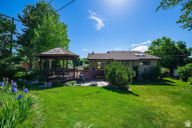 view of grassy yard with a gazebo and a deck