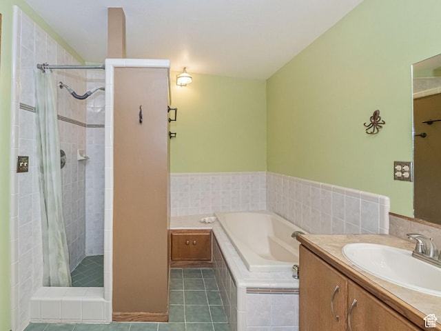 full bath featuring a stall shower, tile patterned flooring, vanity, and a bath