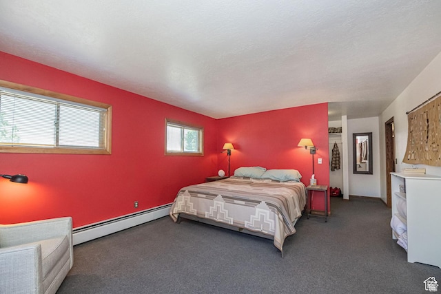 bedroom featuring a baseboard heating unit and carpet