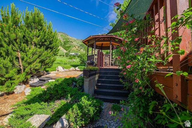 view of yard with a mountain view and a gazebo