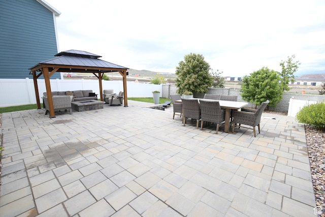 view of patio / terrace with outdoor lounge area, outdoor dining space, a gazebo, and a fenced backyard