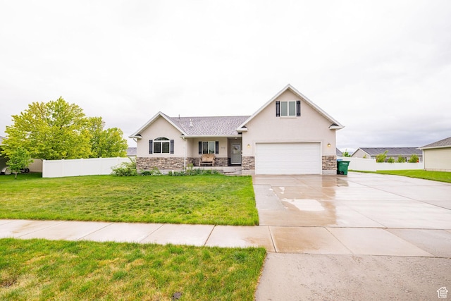 view of front of property with driveway, stucco siding, stone siding, and a garage