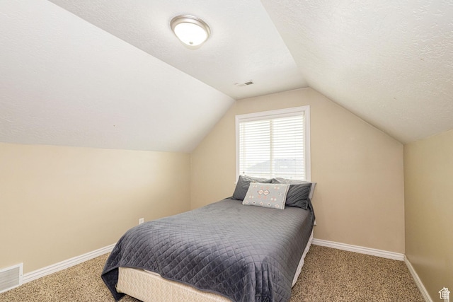 bedroom featuring carpet floors, baseboards, lofted ceiling, and a textured ceiling
