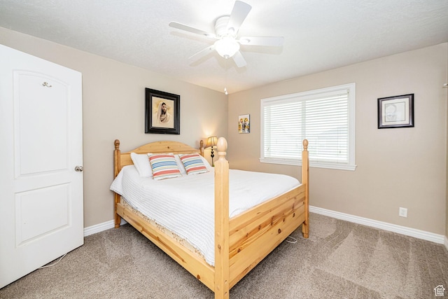 bedroom with light carpet, baseboards, and ceiling fan