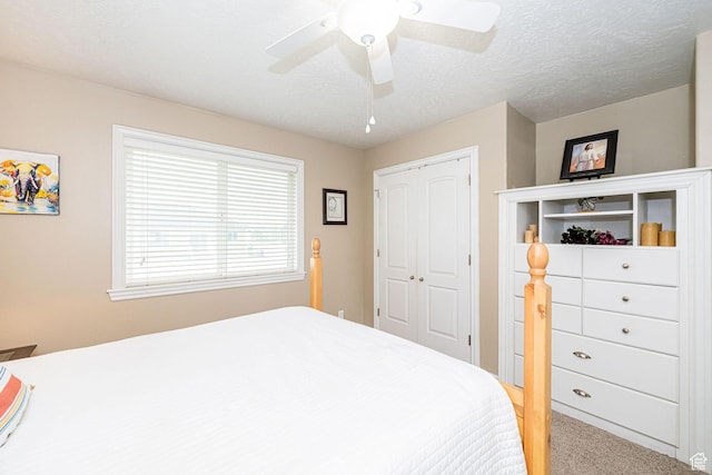 carpeted bedroom with a closet and a ceiling fan
