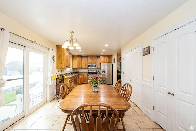 dining area featuring light tile patterned floors, healthy amount of natural light, a chandelier, and recessed lighting
