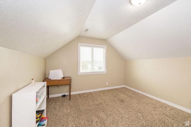 bonus room featuring lofted ceiling, carpet flooring, baseboards, and a textured ceiling