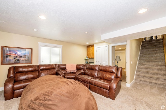 living room with light colored carpet, recessed lighting, stairway, baseboards, and a textured ceiling