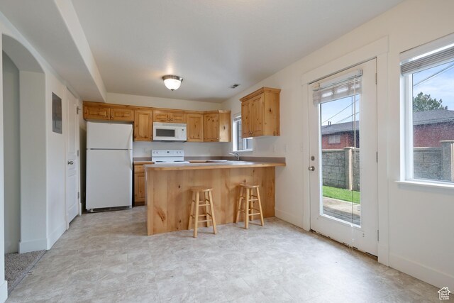 381 S State St E Unit 12, Provo, UT 84606 - kitchen with white appliances, plenty of natural light, a peninsula, and light countertops