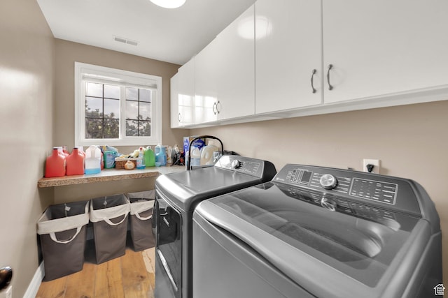 13856 S Cromwell Ln E, Draper, UT 84020 - clothes washing area with cabinet space, washing machine and clothes dryer, and light wood finished floors