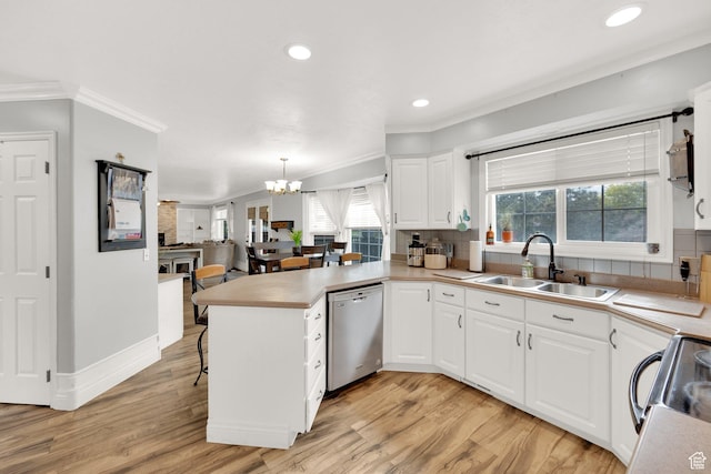 13856 S Cromwell Ln E, Draper, UT 84020 - kitchen with stainless steel dishwasher, a sink, crown molding, a peninsula, and backsplash
