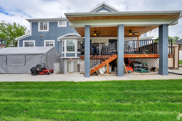 13856 S Cromwell Ln E, Draper, UT 84020 - back of house featuring ceiling fan, a lawn, stairs, stucco siding, and a patio