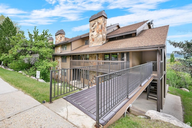 3615 N Wolf Lodge Dr Unit 1109, Eden, UT 84310 - back of property featuring a chimney, stairs, a shingled roof, and a porch