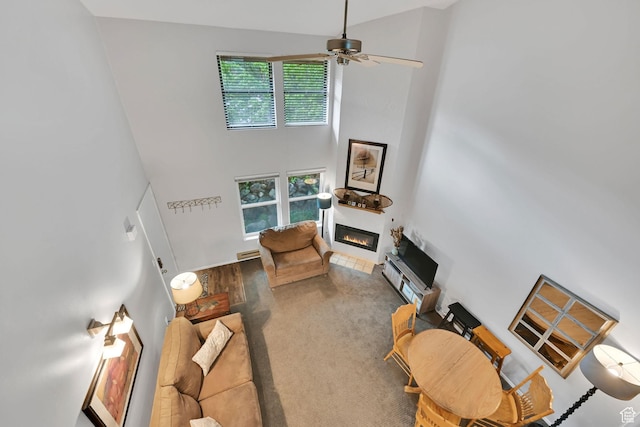 3615 N Wolf Lodge Dr Unit 1109, Eden, UT 84310 - living room featuring a towering ceiling, a glass covered fireplace, and ceiling fan