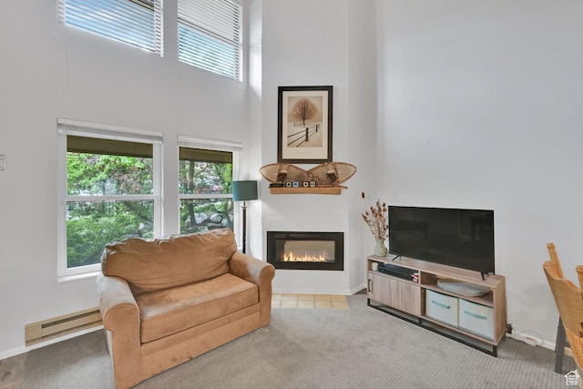 3615 N Wolf Lodge Dr Unit 1109, Eden, UT 84310 - living area with a glass covered fireplace, healthy amount of natural light, a baseboard heating unit, carpet flooring, and a high ceiling