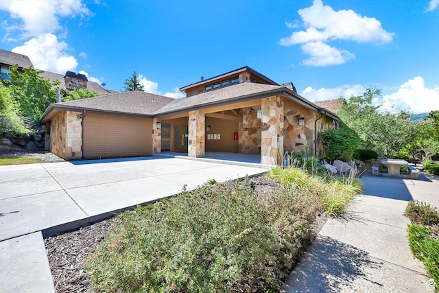 3615 N Wolf Lodge Dr Unit 1109, Eden, UT 84310 - view of front facade featuring stone siding, driveway, and roof with shingles