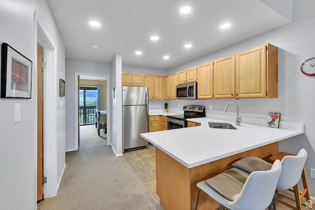 3615 N Wolf Lodge Dr Unit 1109, Eden, UT 84310 - kitchen with stainless steel appliances, a sink, light brown cabinetry, light countertops, and a peninsula