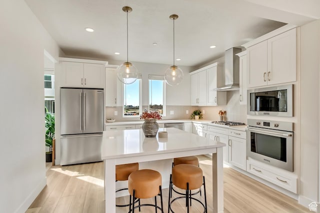 1476 W Cook Ln N Unit 162, Farmington, UT 84025 - kitchen featuring stainless steel appliances, wall chimney exhaust hood, light wood-type flooring, white cabinets, and recessed lighting
