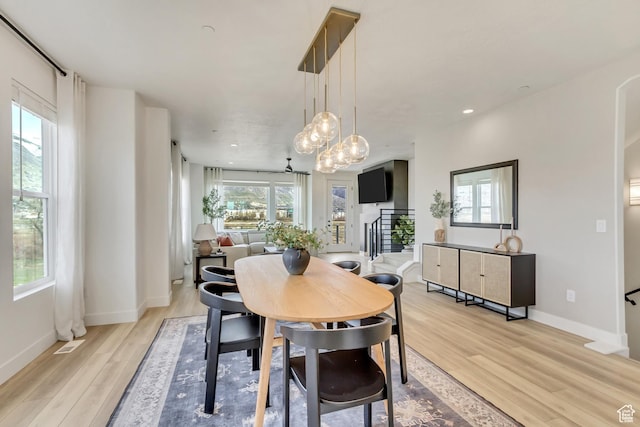 1476 W Cook Ln N Unit 162, Farmington, UT 84025 - dining area featuring light wood-type flooring, baseboards, and a chandelier