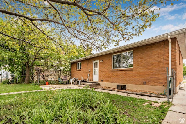 view of front of property featuring brick siding and a patio
