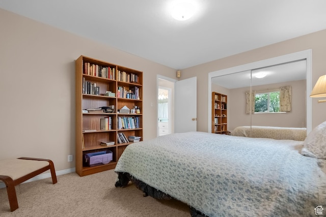 bedroom featuring carpet, baseboards, and a closet