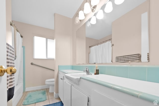 bathroom featuring vanity, tile patterned flooring, toilet, and baseboards
