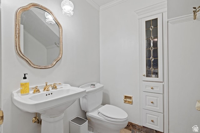 half bath featuring ornamental molding and toilet